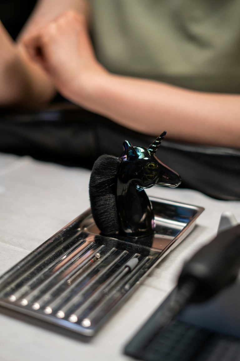 Close-up of a unicorn-inspired manicure set on a table in a nail salon.
